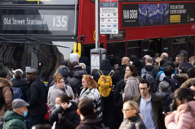 Commuters wait to get on a bus near Liverpool Street Station