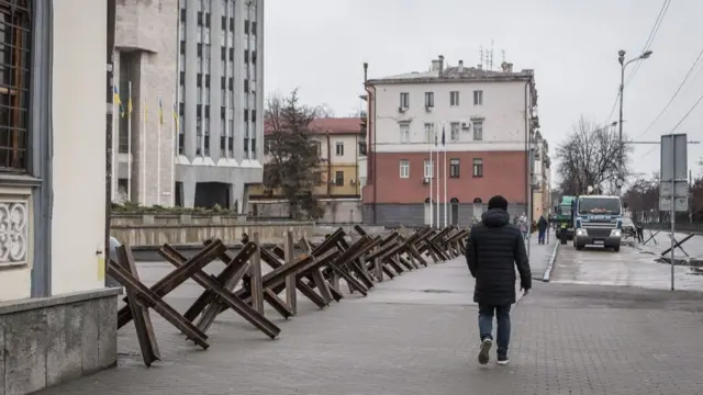A man walks past defences in Dnipro
