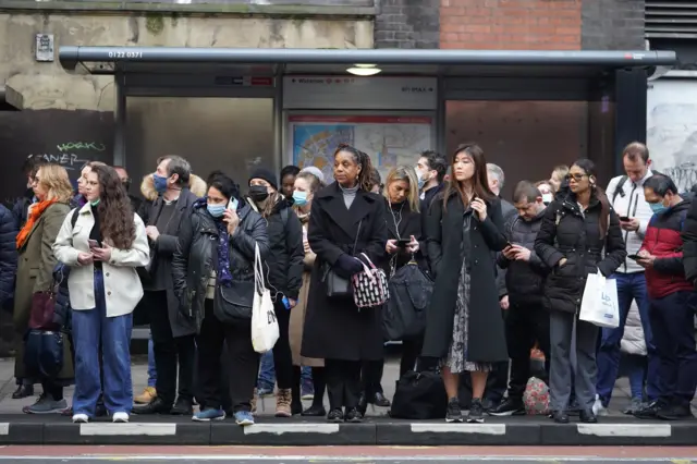 People wait for buses at Waterloo station in London