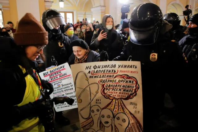 Law enforcement officers escort an elderly woman during an anti-war protest against Russia"s invasion of Ukraine, in Saint Petersburg, Russia March 2, 2022.