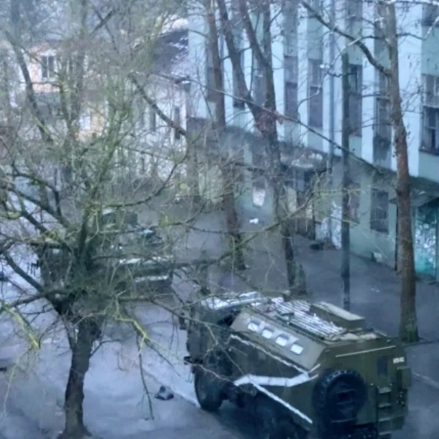 A military truck and tank are seen on a street of Kherson, Ukraine - 1 March 2022
