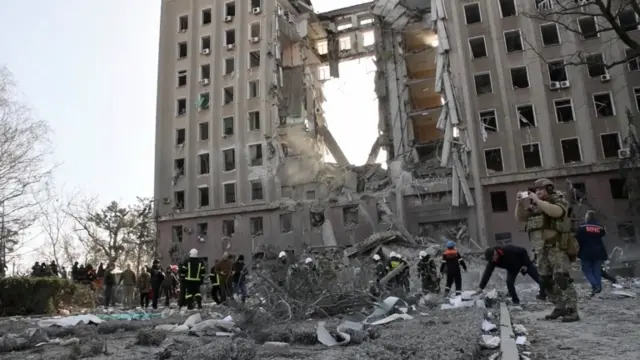 Damage caused by a rocket which tore a hole through a nine-storey government building in Mykolaiv on Tuesday