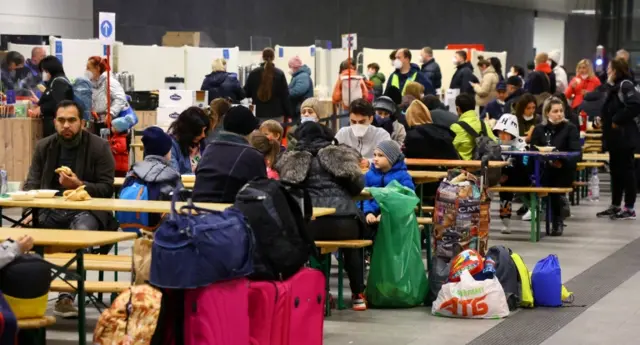 People fleeing from Ukraine eat and get some rest at a welcome centre upon their arrival at Berlin"s Hauptbahnhof central station,