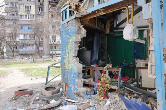 A view of damaged buildings and vehicles after shelling in the Ukrainian city of Mariupol under the control of Russian military and pro-Russian separatists, on March 29, 2022.