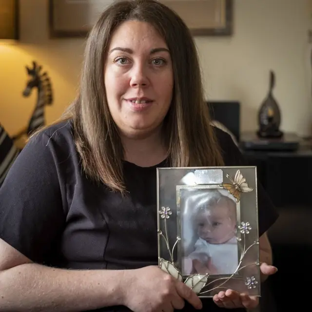 Carley McKee with a photo of her daughter Keeley