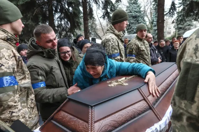 A woman weeps at the funeral of a Ukrainian soldier in Odesa, Ukraine