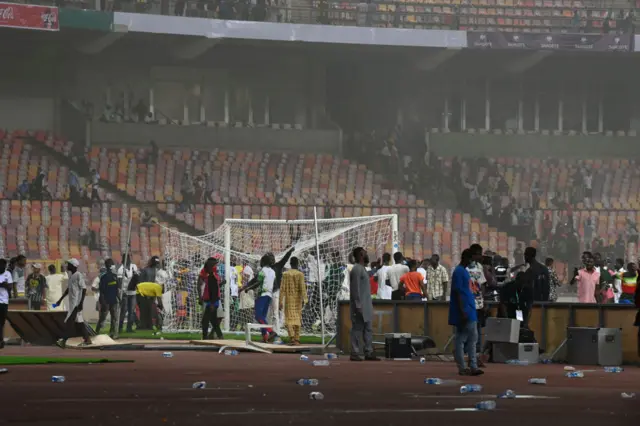 Angry football fans invade the pitch