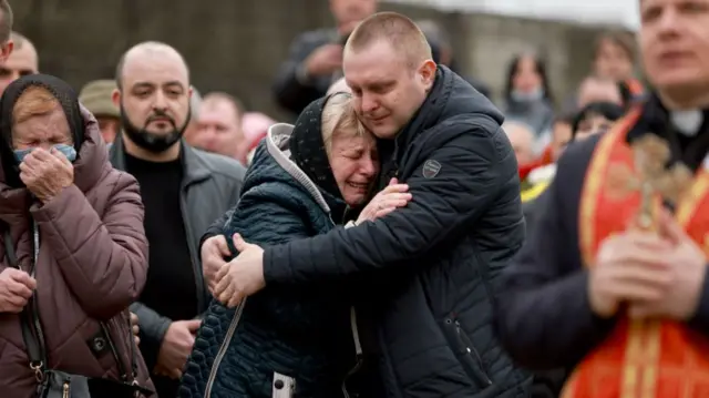 Relatives of a Ukrainian soldier attend his burial in the western city of Lviv