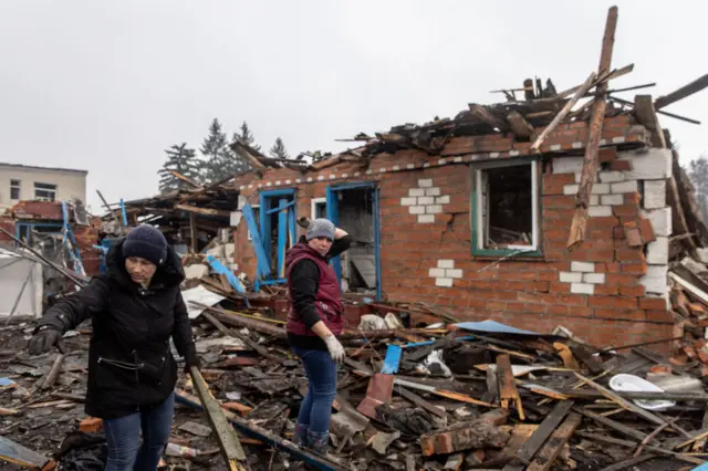 Women searching rubble in Sumy region of UKraine