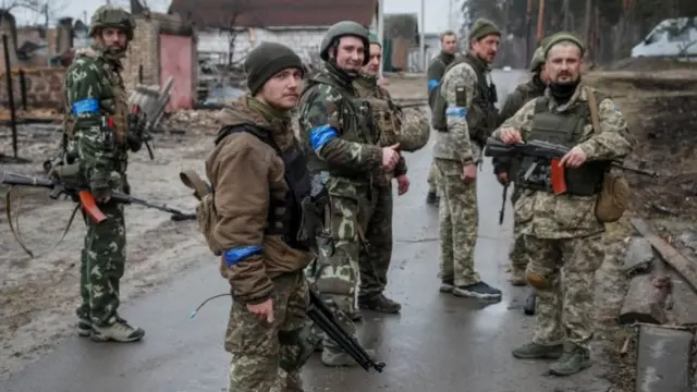 Ukrainian troops stand on the front line near Kyiv