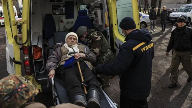 People evacuated from the town of Irpin arrive at a centre in Kyiv