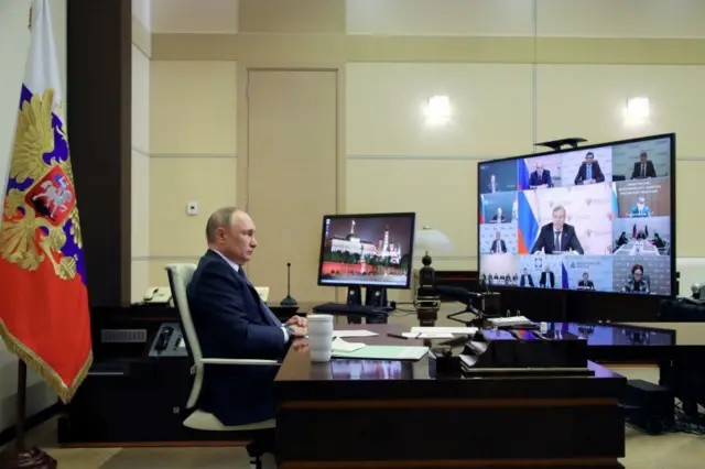 Russian President Vladimir Putin chairs a meeting outside Moscow via videolink