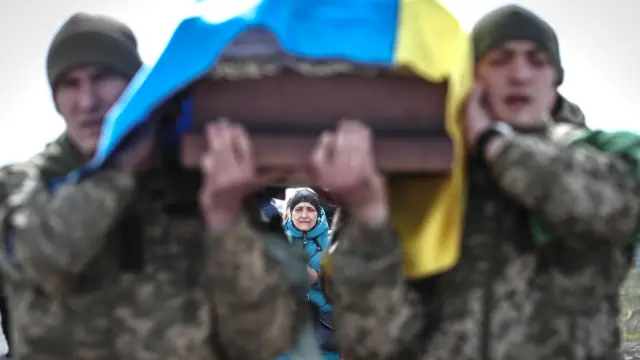 Ukrainian soldiers carry a coffin during the funeral ceremony of a comrade in Odesa, Ukraine