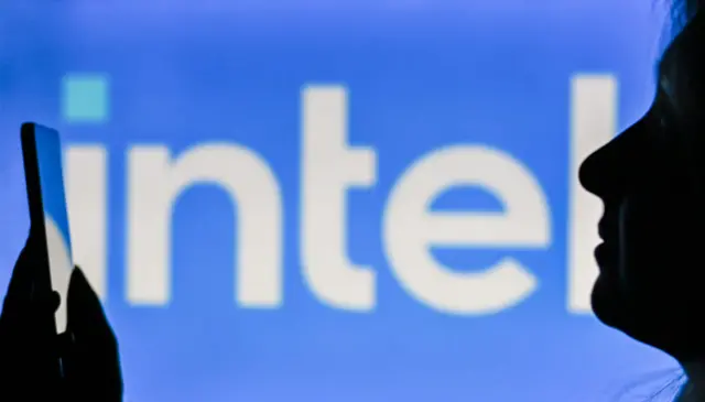 An intel sign with a person in front