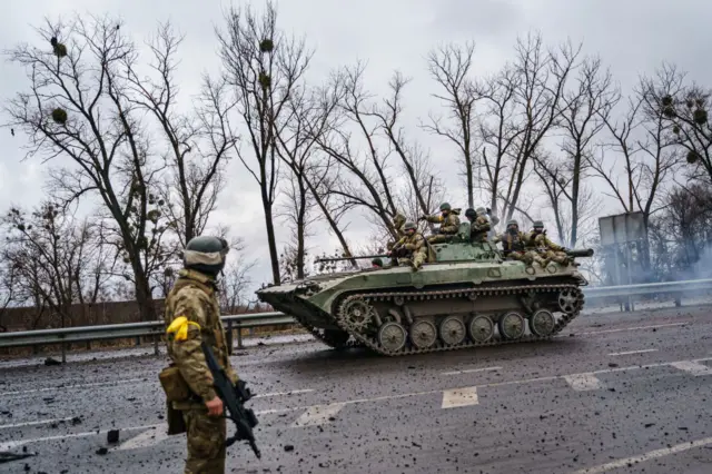 A Ukrainian military vehicle speeds by on a main road near Sytnyaky, Ukraine.