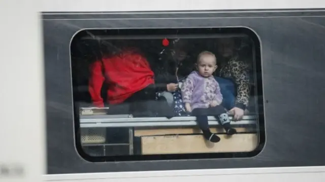 A child looks out from an evacuation train from Kharkiv to Lviv at Kyiv central train station. Photo: 4 March 2022