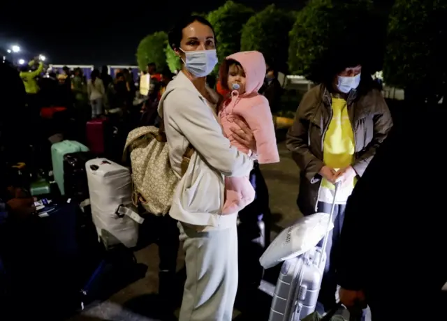 Oksana Guliaieva holds her child at the Benito Juarez International airport in Mexico City, Mexico. 4 March 2022.