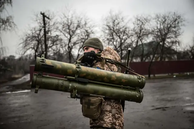 An Ukrainian soldier holds an anti-tank launcher at a frontline, northeast of Kyiv on March 3, 2022