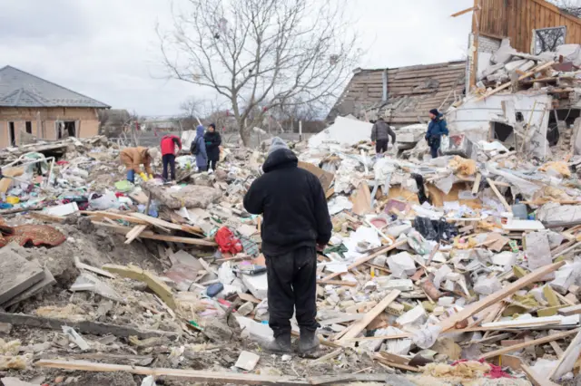 A man standing outside his destroyed house in Markhalivka, Ukraine on 5 March