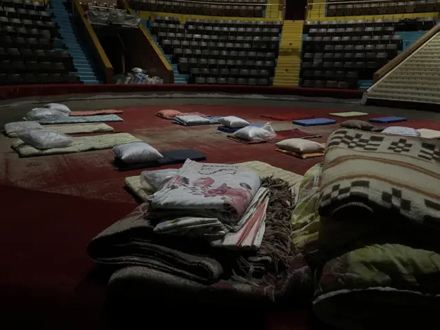 Close-up of mattresses and bedding in a circus ring