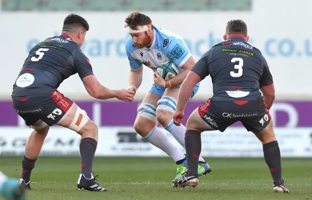 Rob Harley of Glasgow takes on Jac Price and Javan Sebastian of Scarlets