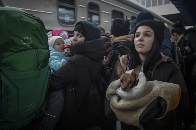 People wait to board an evacuation train at the main railway station in Kyiv, Ukraine