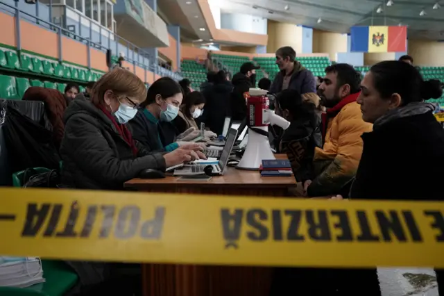 People register at a shelter for refugees