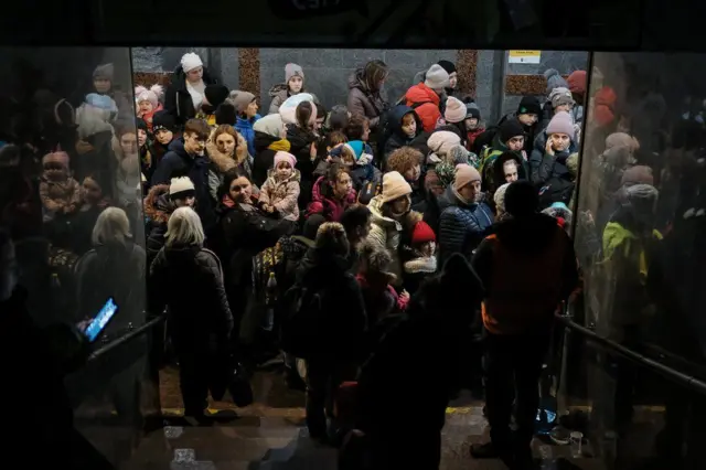 Women and children queue at Lviv station for a train to Poland.