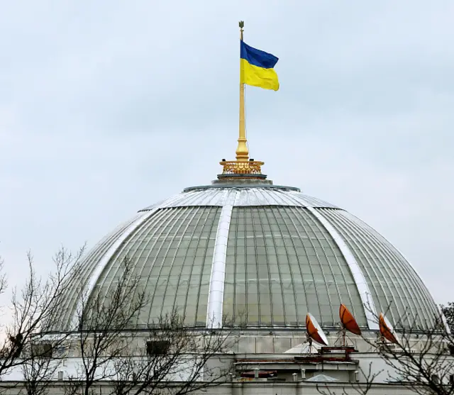 A Ukrainian flag flies above the Rada