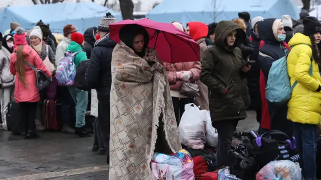 Ukrainians wait to board on evacuation trains at Lviv train station