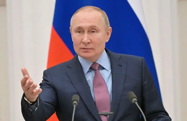 Vladimir Putin gestures as he speaks during a press conference with his Belarus counterpart, following their talks at the Kremlin in Moscow on February 18, 2022