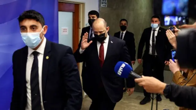 Israeli Prime Minister Naftali Bennett (C) gestures to reporters before a cabinet meeting in Jerusalem on 6 March 2022