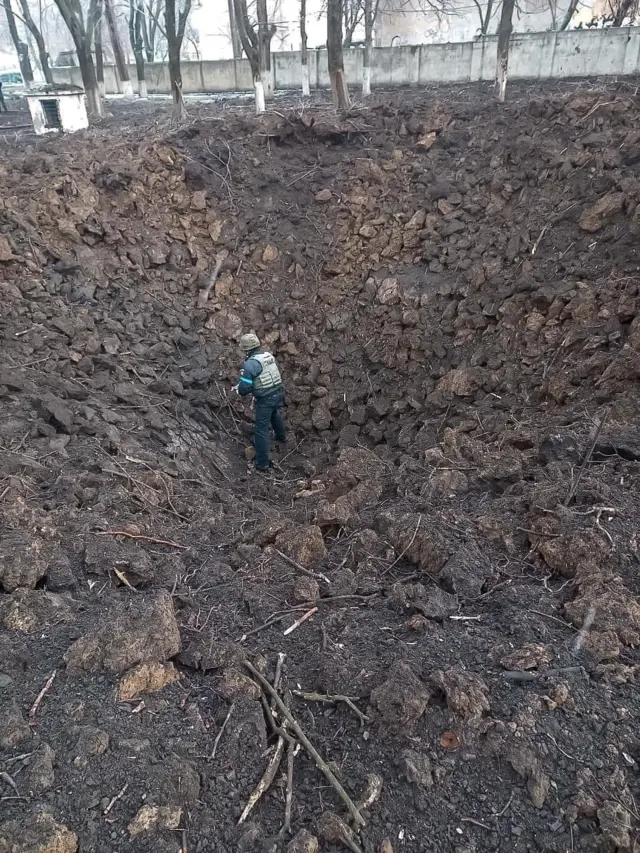 A sapper of the State Emergency Service stands at the bottom of a bomb crater amid Russia"s invasion of Ukraine, in Mariupol, Ukraine