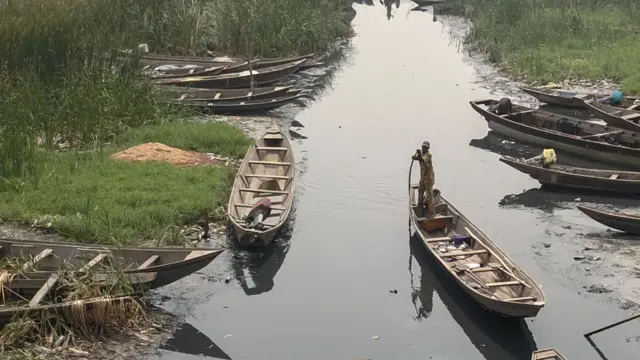 A photo taken on January 22, 2019 shows canoes abandoned by fishermen in the waterfront of Bariga fishing community Lagos