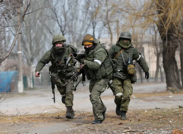 Troops firing grenade launcher