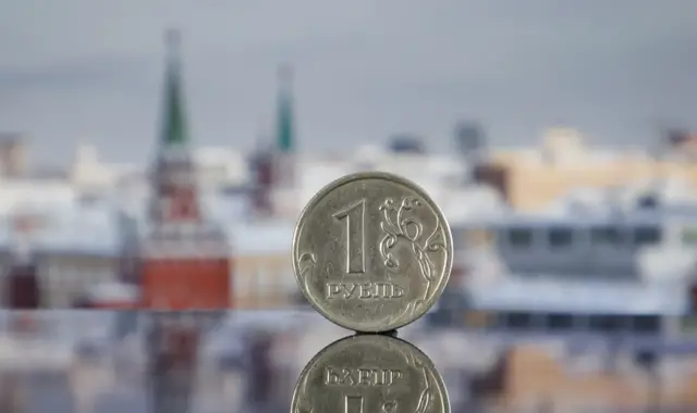 Picture of rouble in front of Russian skyline