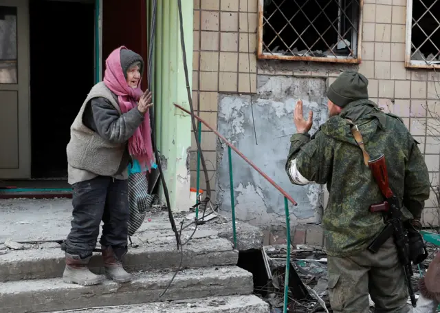 A local resident talks to a pro-Russia troop member