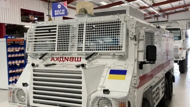 Picture of a military ambulance with a Ukrainian flag in a warehouse