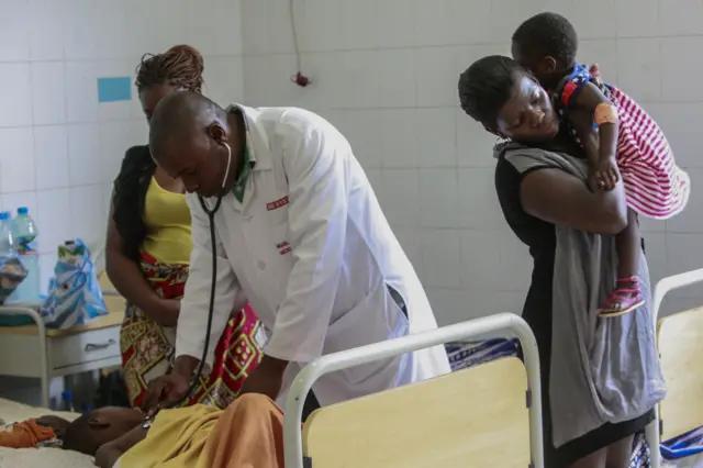 Angolan doctor treating a child