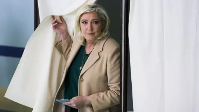 Marine Le Pen, leader of French far-right National Rally (Rassemblement National) party and presidential candidate, exits a polling booth to cast her ballot in the first round of the 2022 French presidential election at a polling station in Henin-Beaumont, France, 10 April 2022.