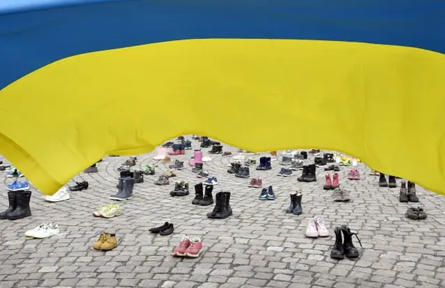 Ukrainian flag flies by memorial in Helsinki