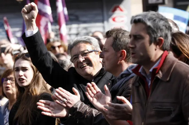 Supporters wave flags of 'La France Insoumise' (LFI) presidential candidate Jean-Luc Melenchon during a parade between the Bastille and the Republic during his traditional presidential march on 20 March 2022 in Paris,