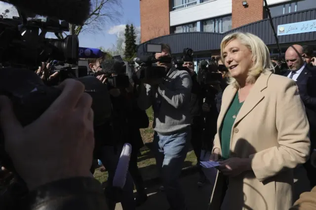 Marine Le Pen, leader of French far-right National Rally (Rassemblement National) party and presidential candidate, talks to journalists after voting in the first round of the 2022 French presidential election at a polling station in Hénin-Beaumont, France, on 10 April 2022