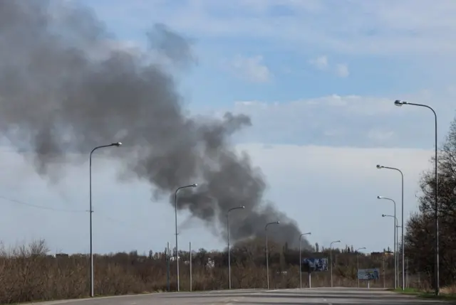 Smoke rises from the airport of Dnipro, on 10 April