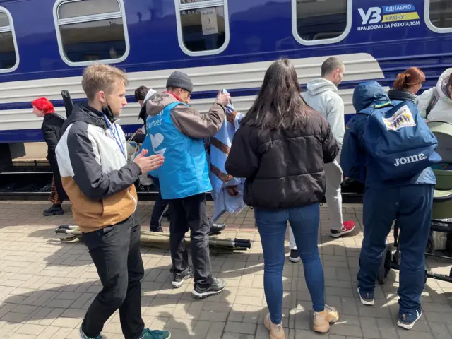 Roksolana helping refugees arriving in Lviv train station