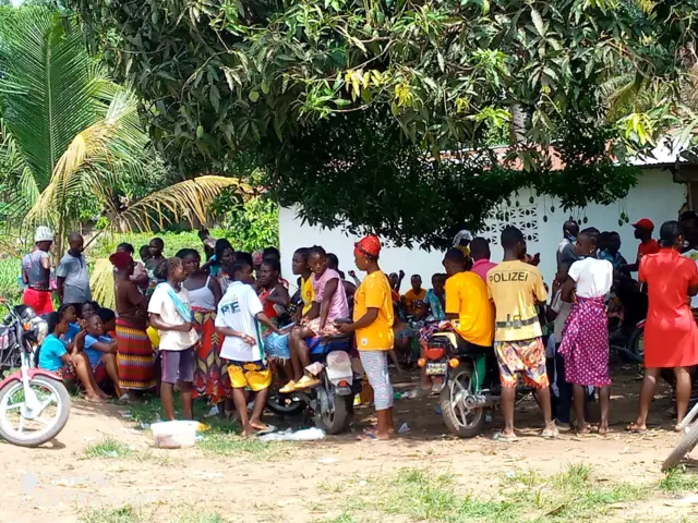 Resident gather in Ganta, which borders Guinea