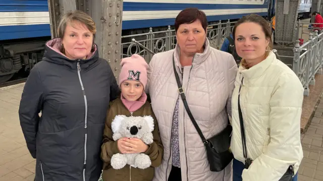 The family standing at the train station