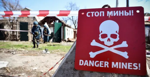 a warning sign against mines