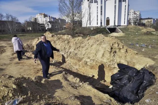 People search for missing relatives at mass grave in Bucha