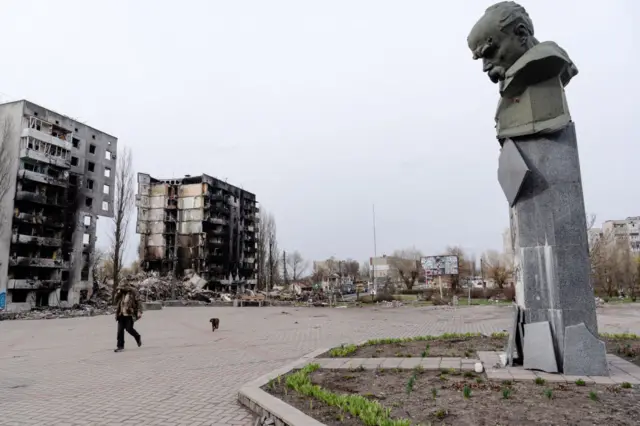 Destroyed residential buildings in Borodyanka and a badly damaged statue